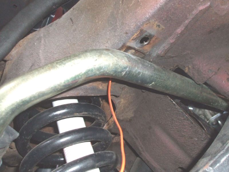 Feeding wire through sway bar hole